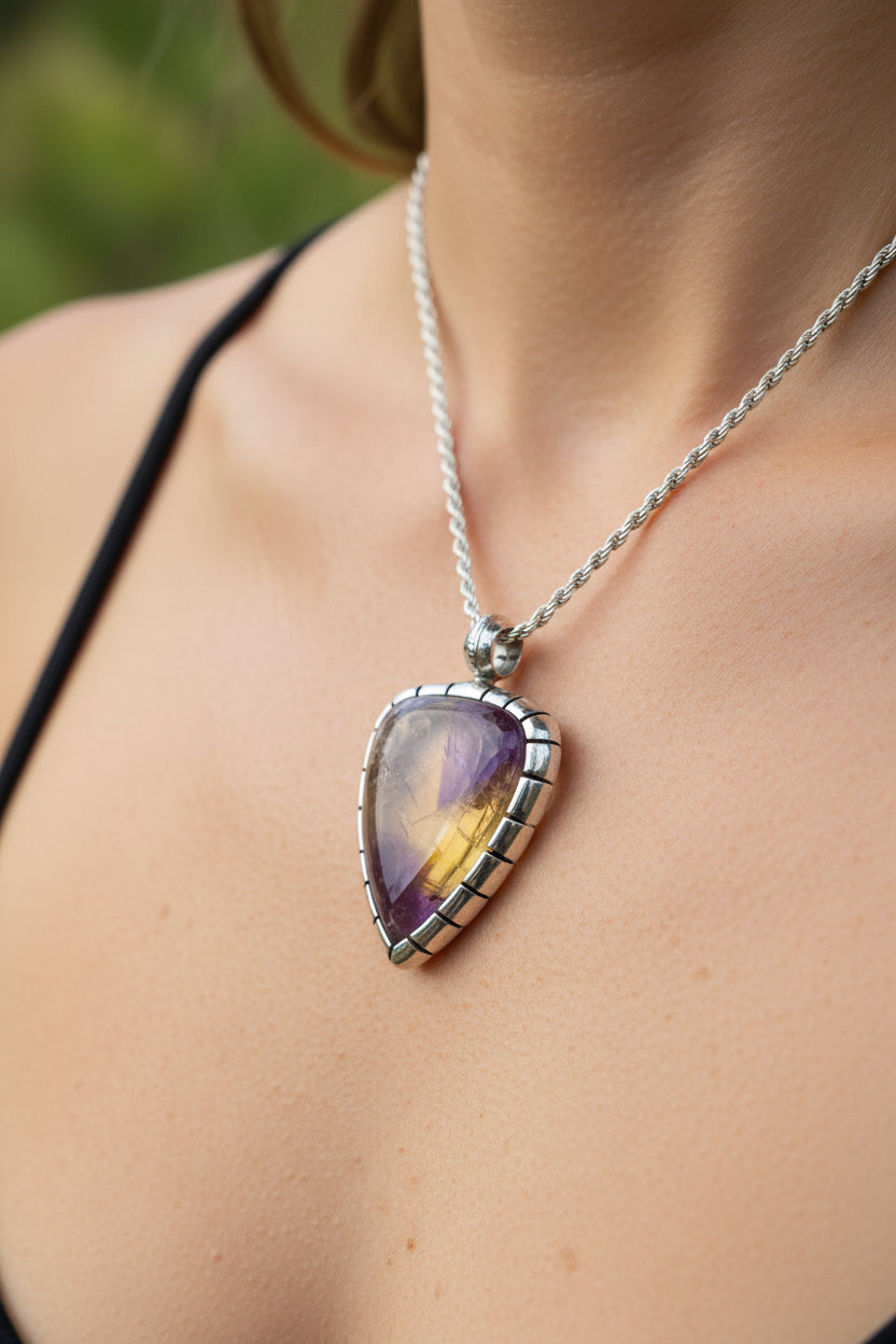 Necklace with a multicolored gemstone pendant against a natural background